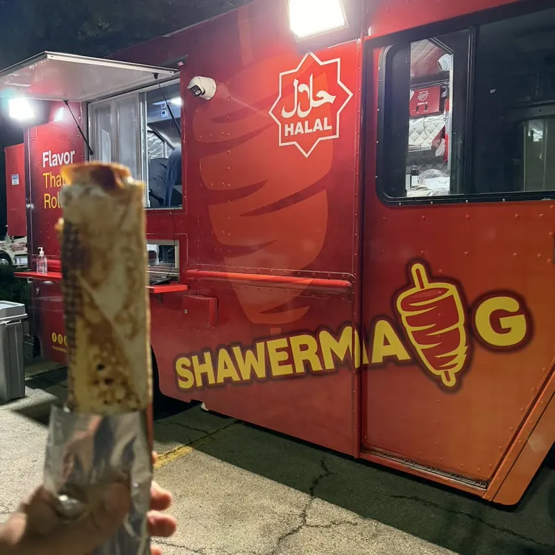 A finished shawerma wrap, golden and crisp, steam rising